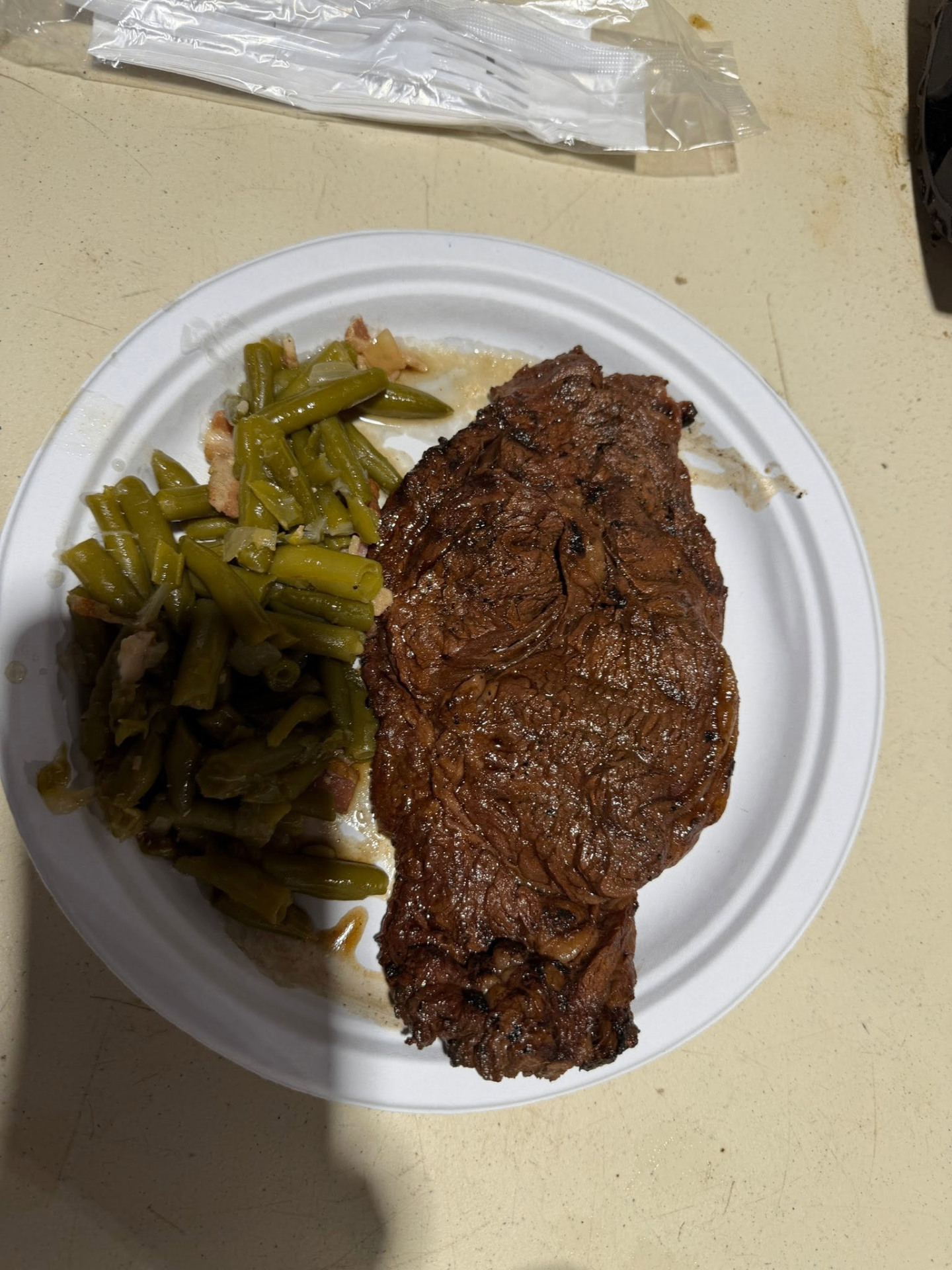 Ribeye steak and green beans served at Steak Night